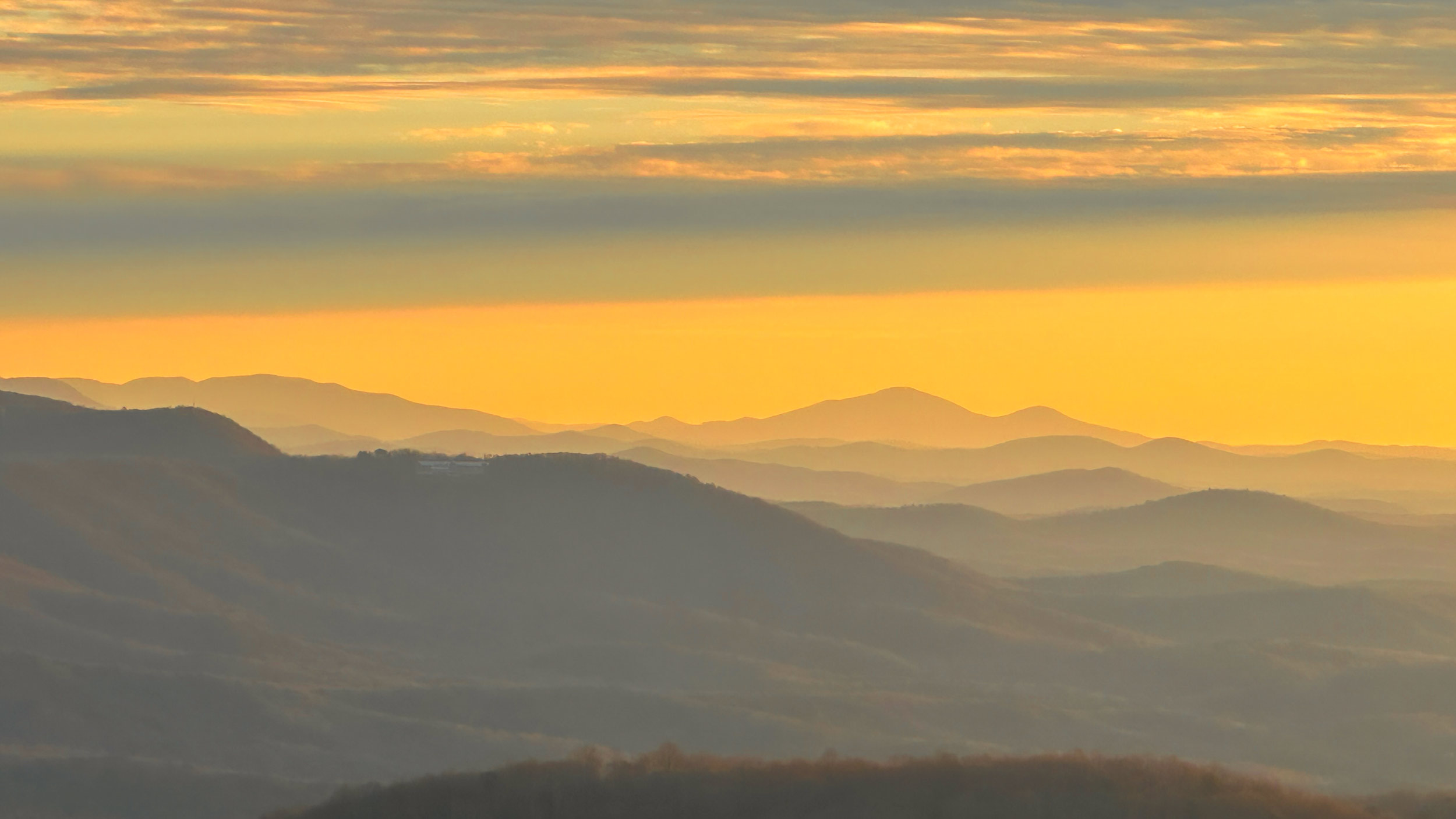 010 2025 11 27 golden morning light over layered ridges